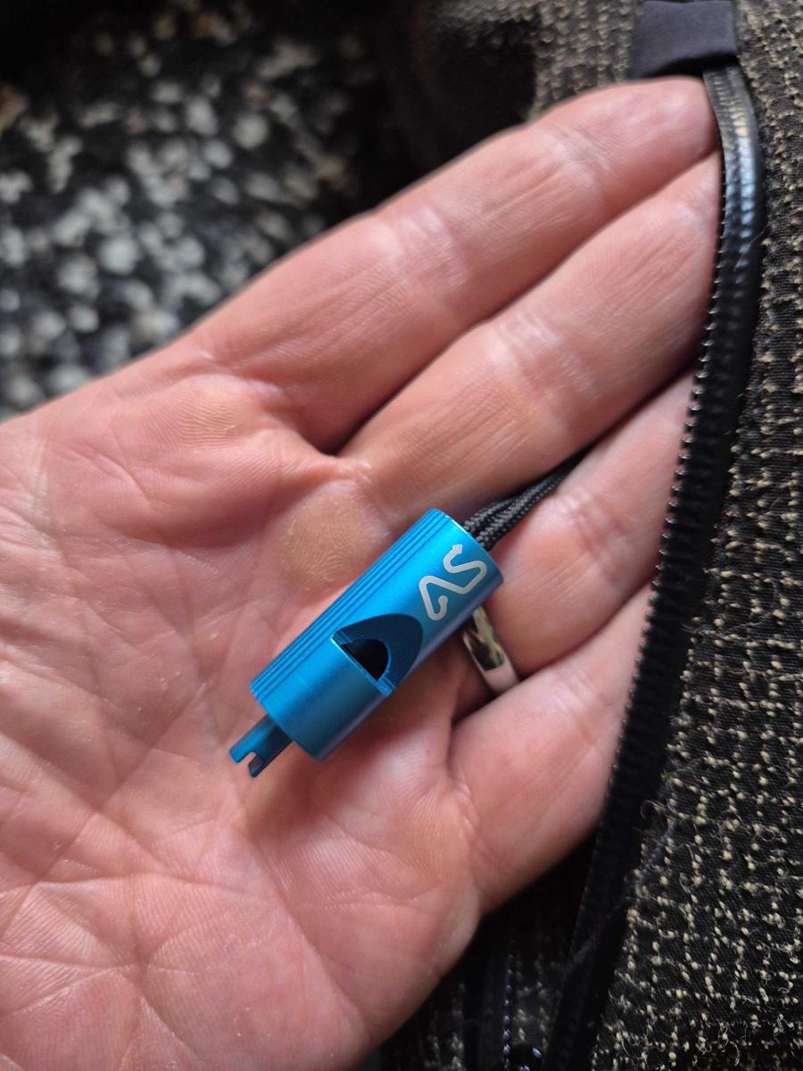 The blue anodised emergency whistle clipped inside a Linesman jacket pocket
