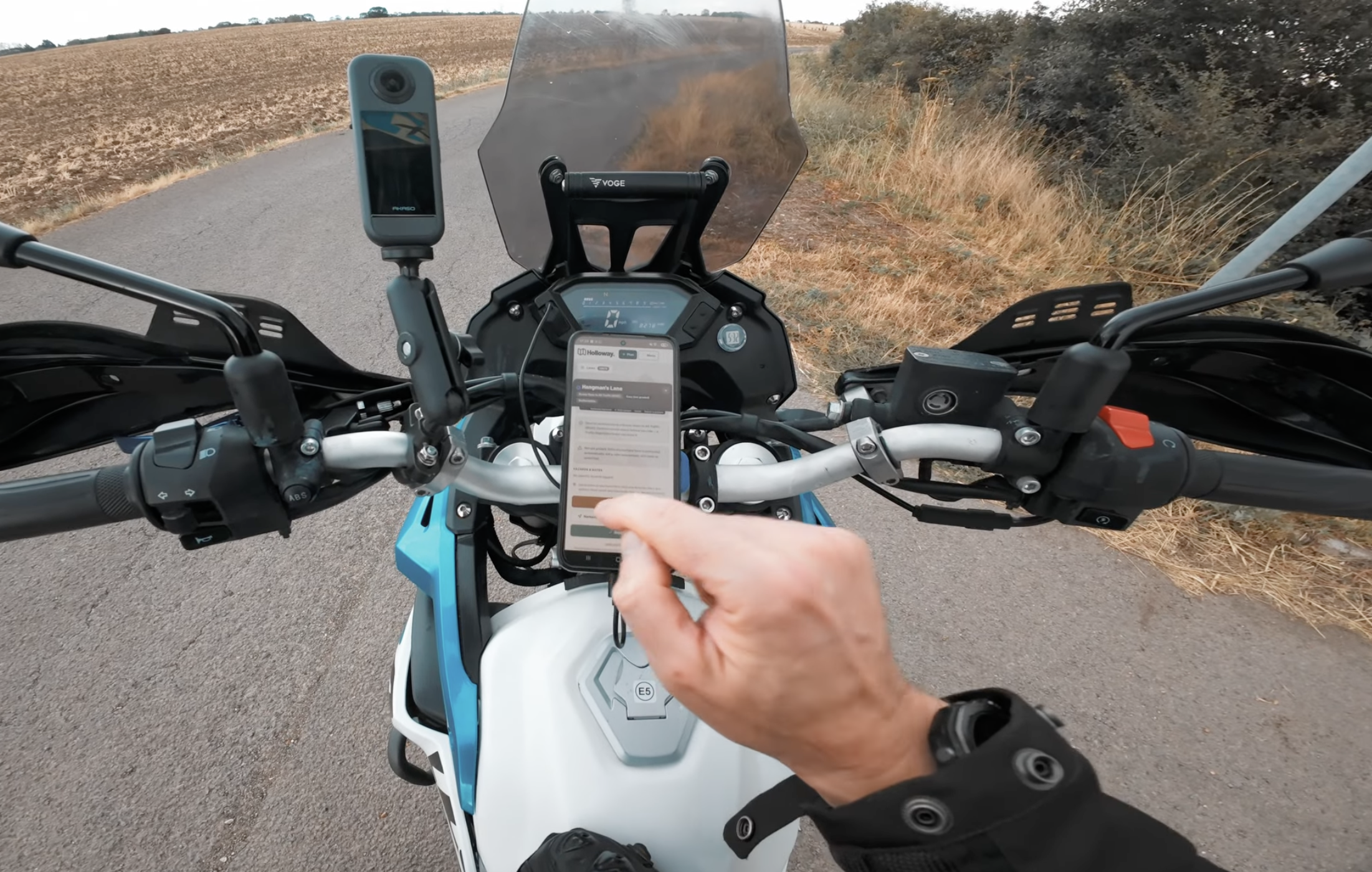 A rider checking a lane's legal status on Holloway, phone mounted on the handlebars mid-ride